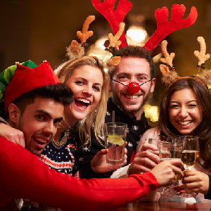 A group of 4 friends raising the glass while smiling at the camera